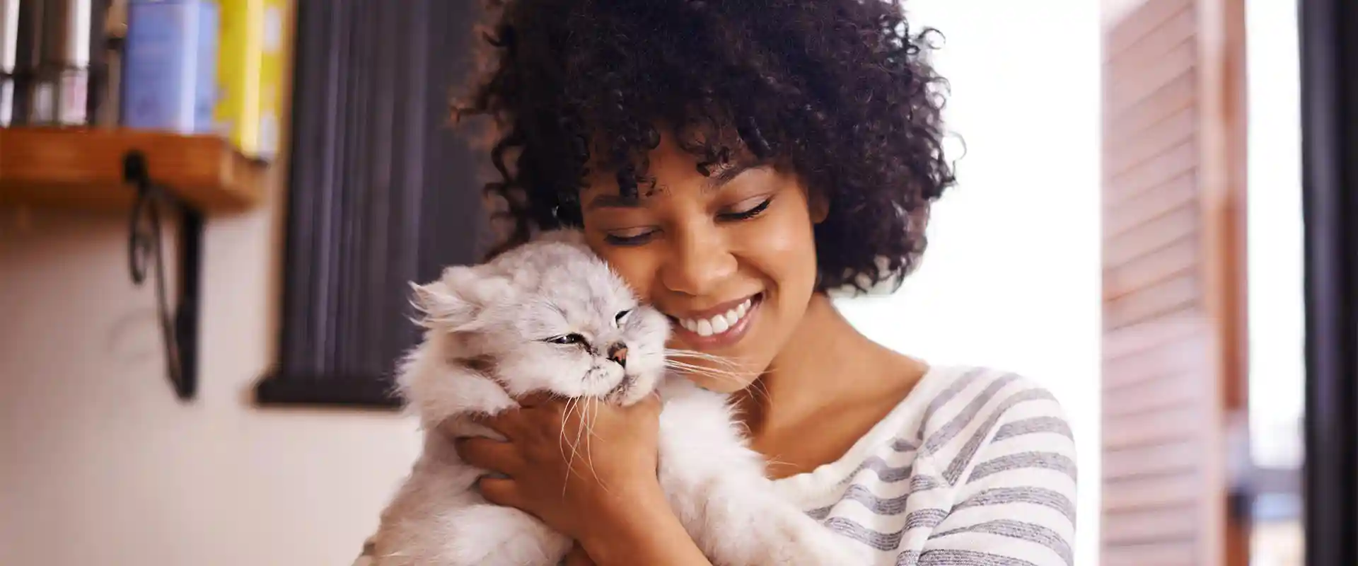A woman hugging her cat